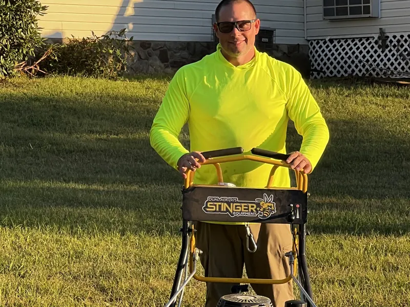 Jimmy Terry with the walk-behind core aerator before starting a lawn