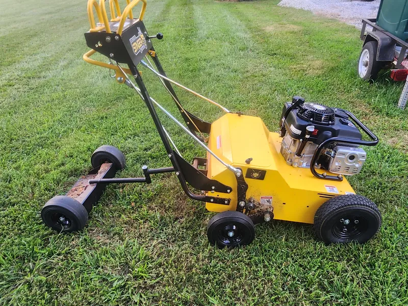 Core aerator on a lawn before a fall aeration job