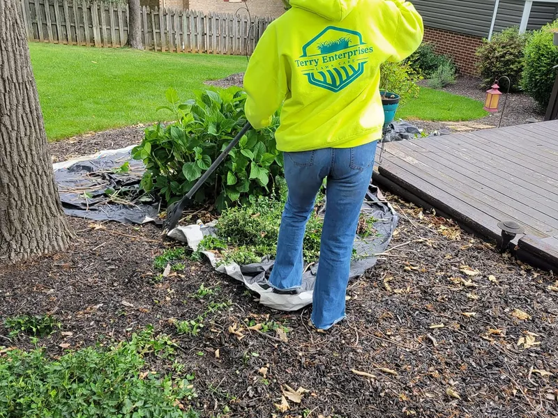 Terry Enterprises crew member clearing a bed with tarps laid out