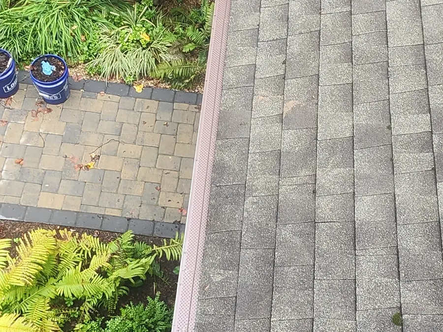 Perforated aluminum gutter guard fitted above a paver walk in Hardy, VA