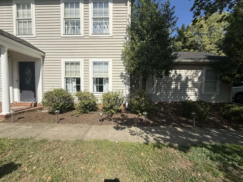 Foundation bed with overgrown nandinas before renovation in Roanoke, VA