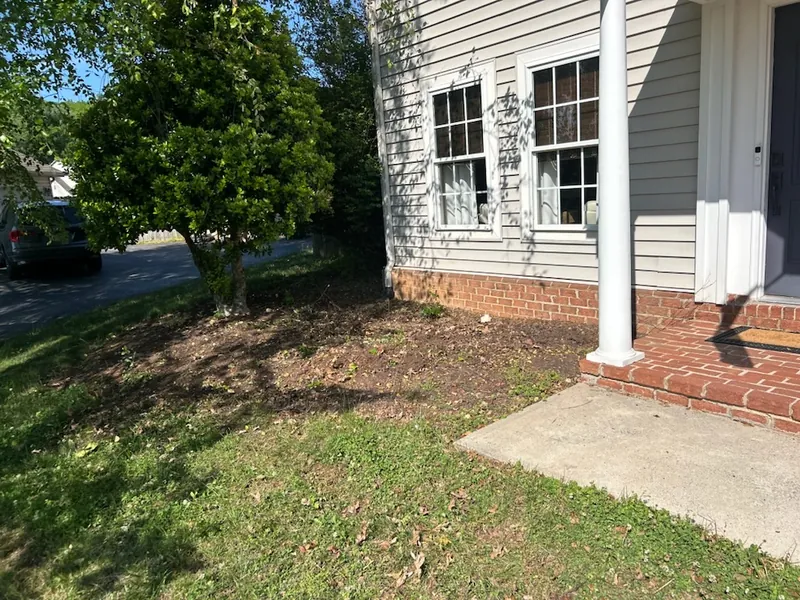 Bed stripped to bare soil after the old planting was removed in Roanoke, VA