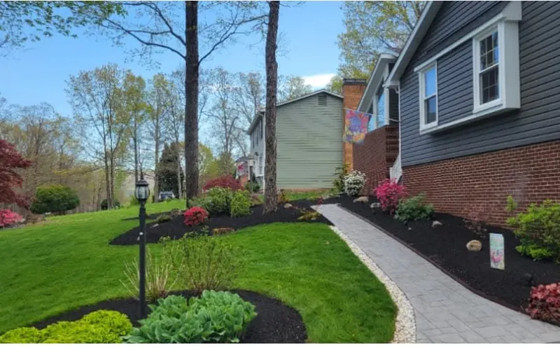 Freshly mulched beds around a paver walkway